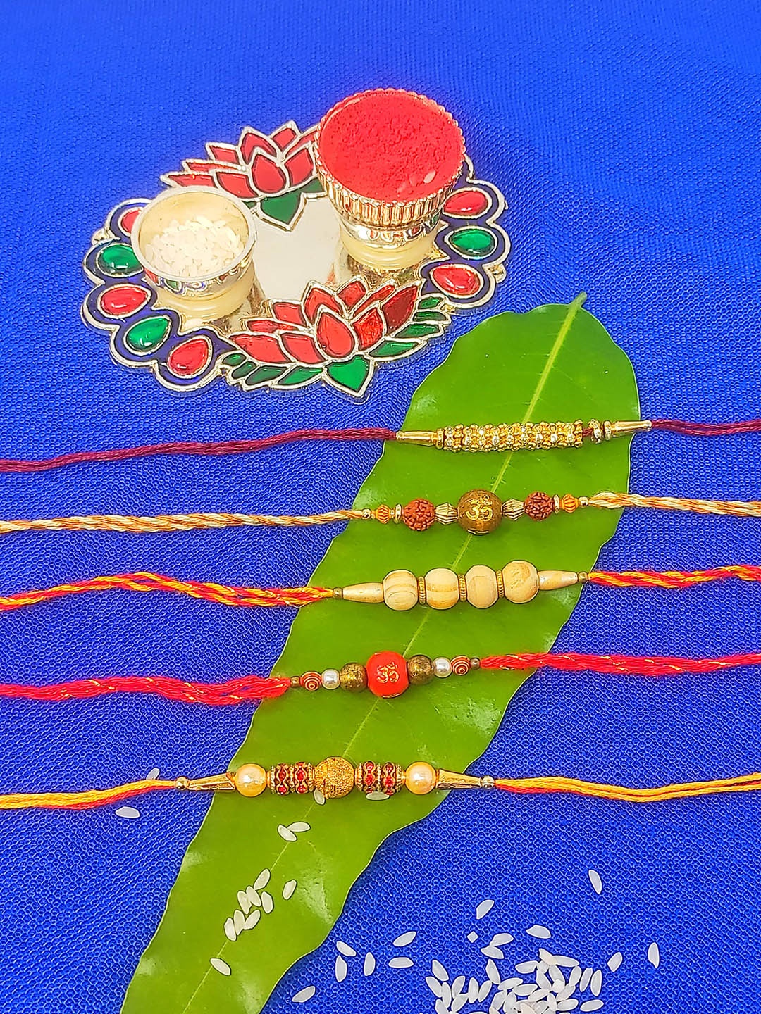 

CRAYTON Set of 5 Beaded Thread Rakhi With Roli Chaval Holder, Red
