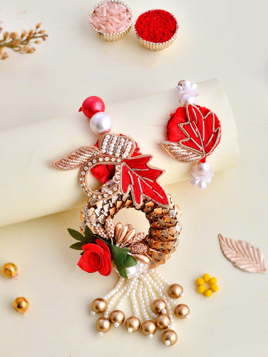 

Aapno Rajasthan Unisex Set Of 2 Floral Embellished & Pearl Beaded Rakhi Gift Set, Red