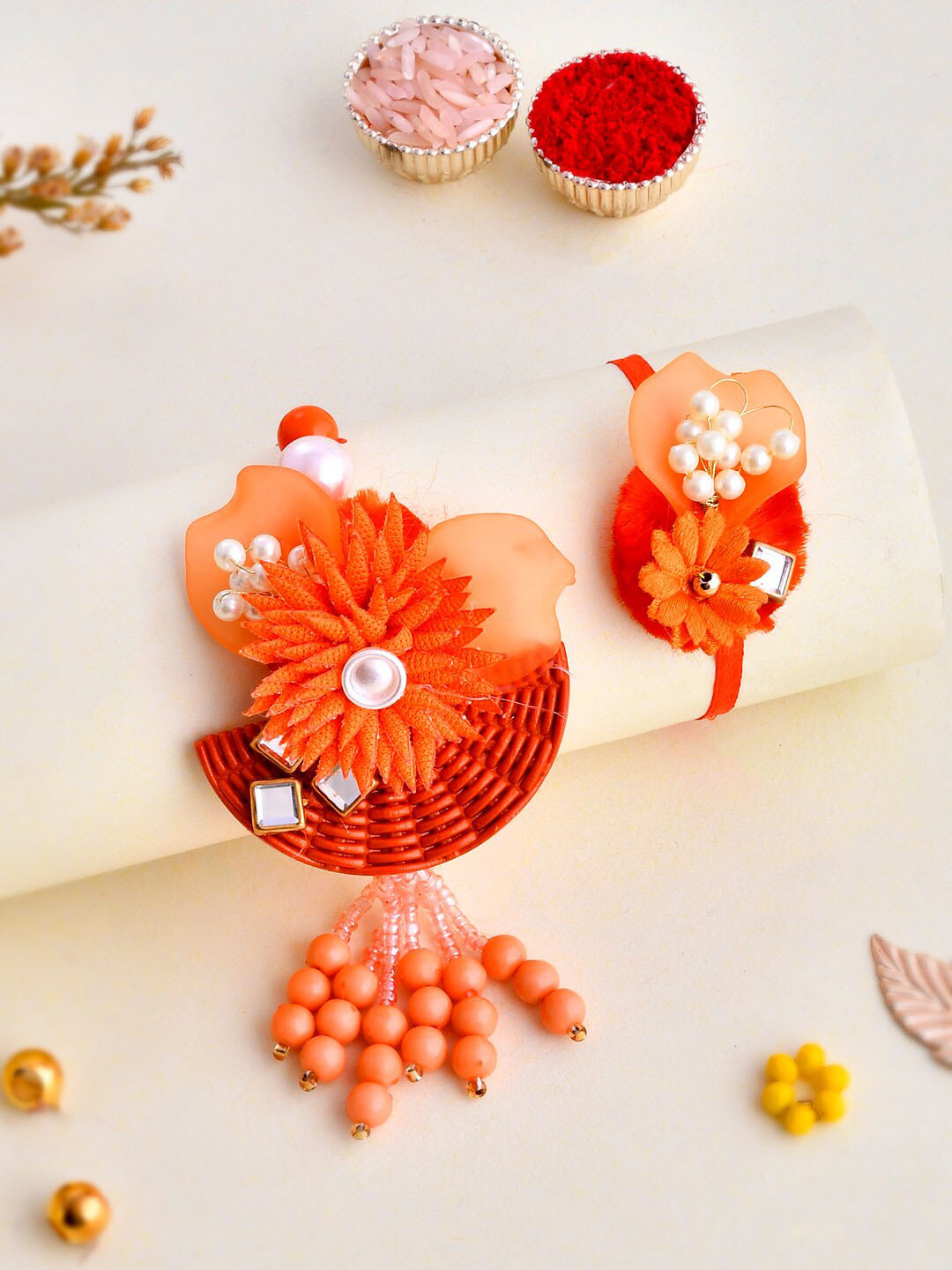 

Aapno Rajasthan Unisex Set Of 2 Floral Embellished Rakhi Gift Set, Orange