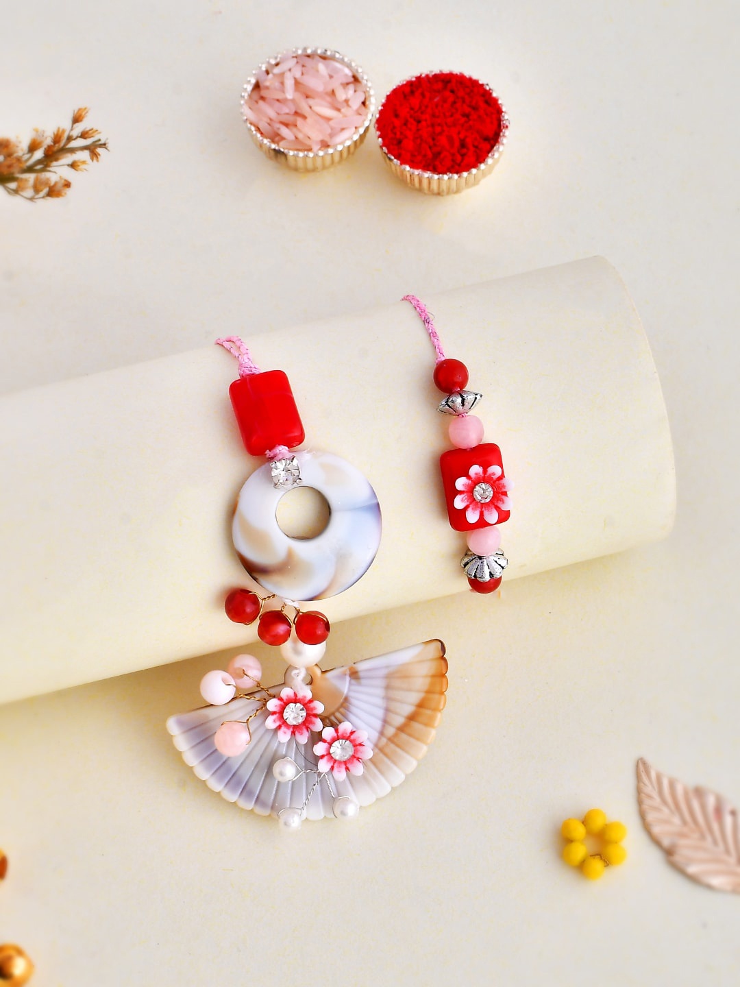 

Aapno Rajasthan Set Of 2 Pearl & Beads Bhaiya Bhabhi Rakhis With Tilak Pack & Message Card, Pink