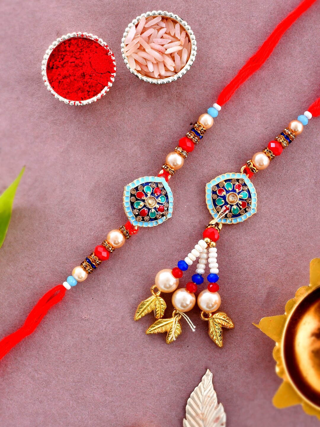 

Aapno Rajasthan Unisex Kundan Studded With Pearl Balls Bhaiya Bhabhi Rakhi Gift Set, Red