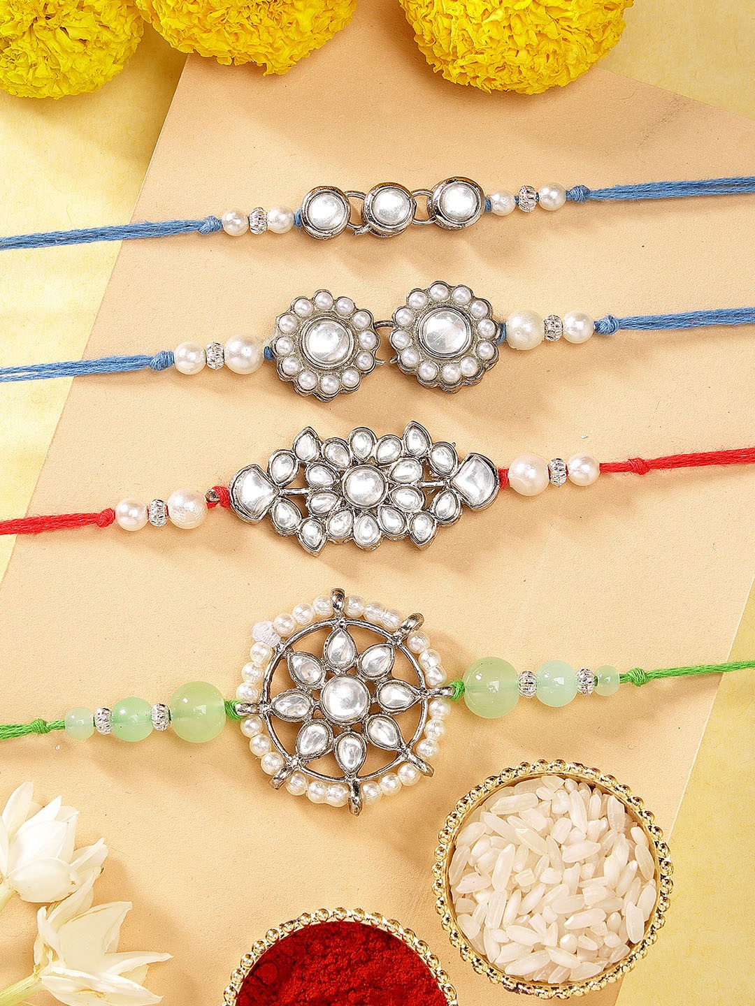 

Karatcart Set of 4 Silver-Plated Kundan Rakhi with Roli & Chawal, Blue