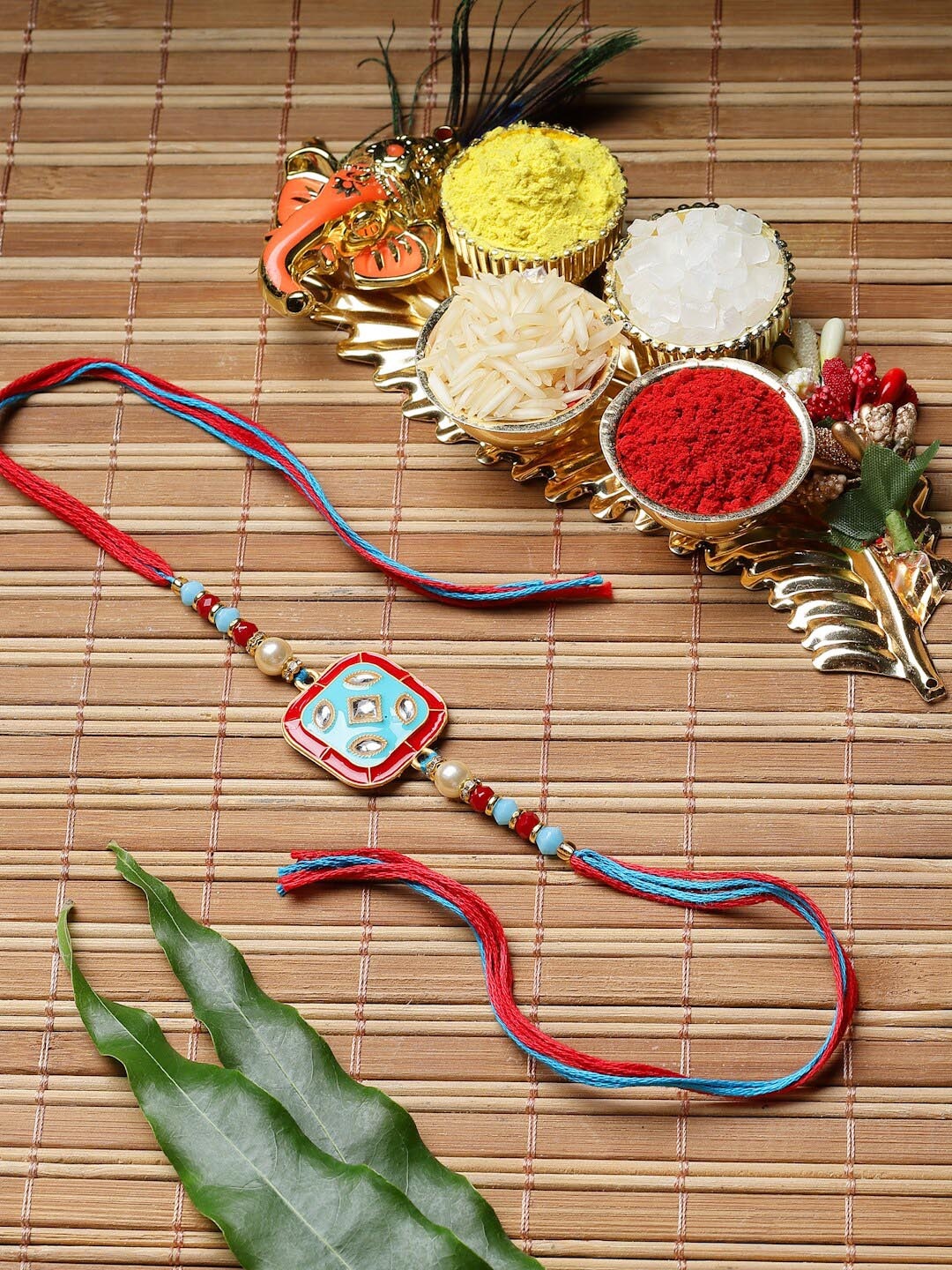 

ZENEME Kundan Studded Enamelled Thread Rakhi With Roli & Chawal, Red