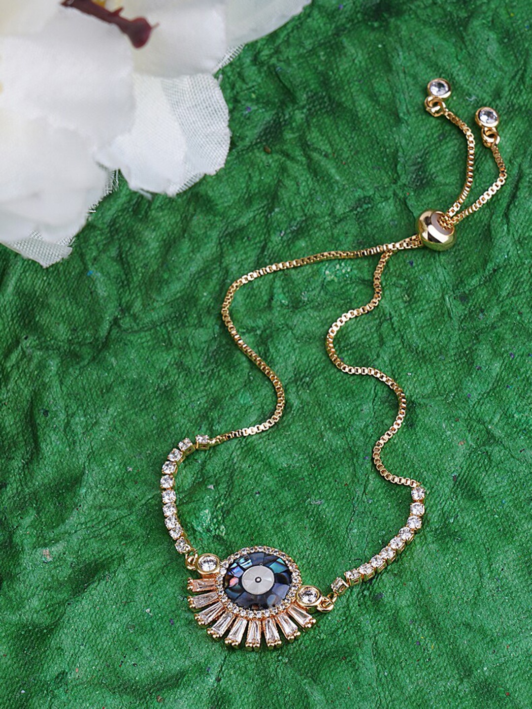 

AURAA TRENDS Women Rhodium-Plated AD-Studded Rakhi, Gold