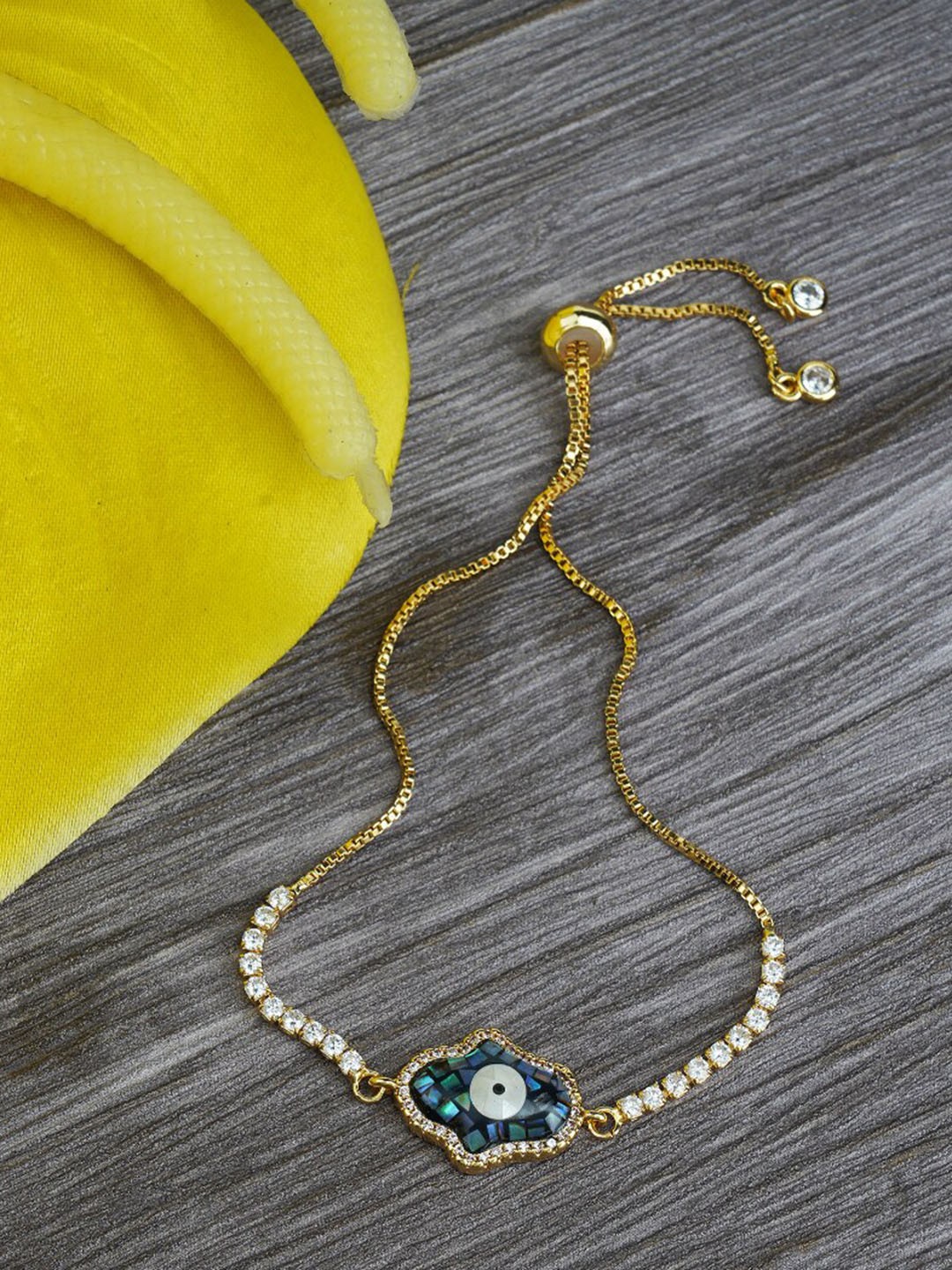 

AURAA TRENDS Women Rhodium-Plated AD-Studded Rakhi, Gold
