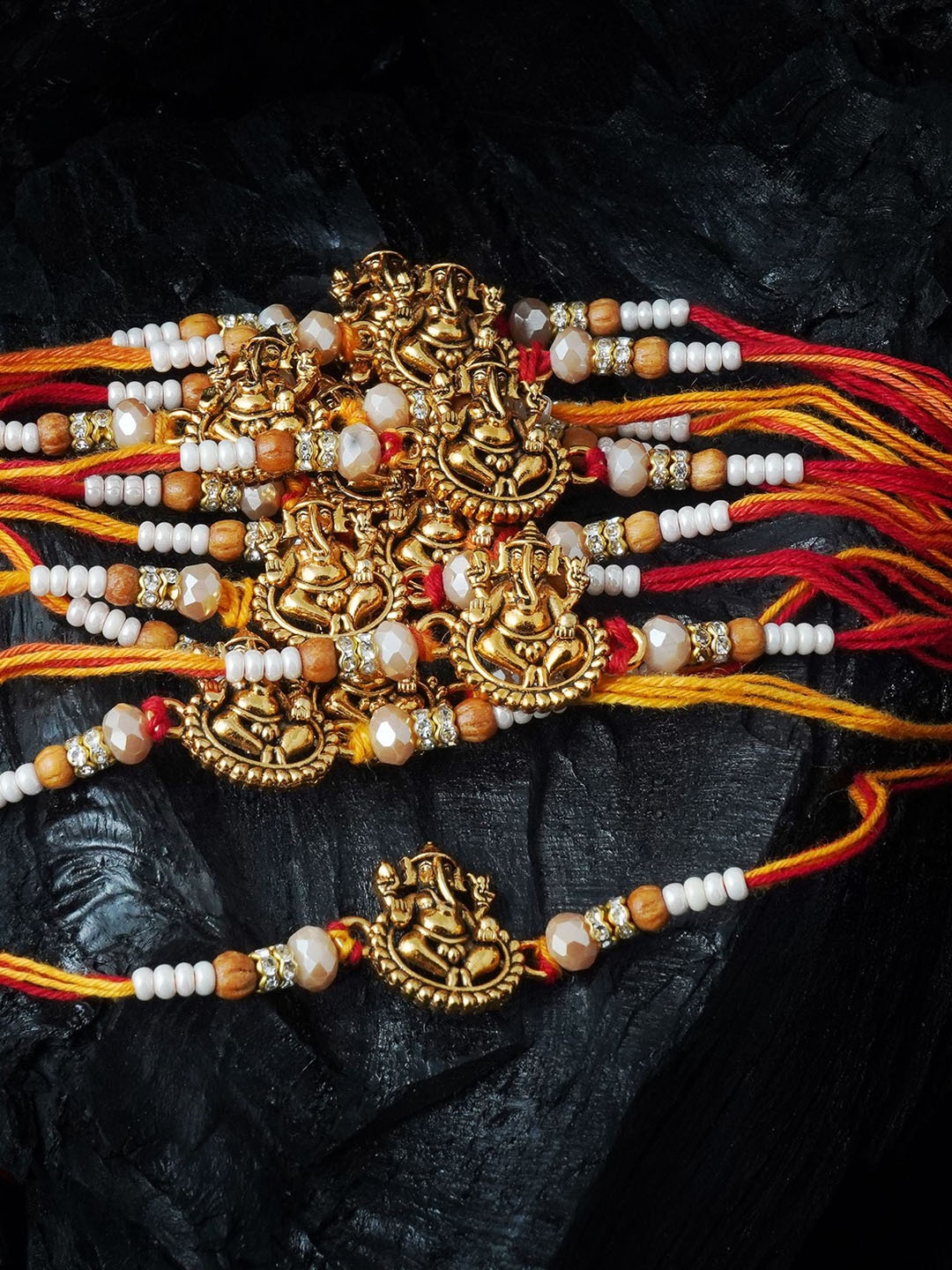 

MANSIYAORANGE Men Set Of 12 Pearl & Ganesha Cotton Charm Rakhi, Gold