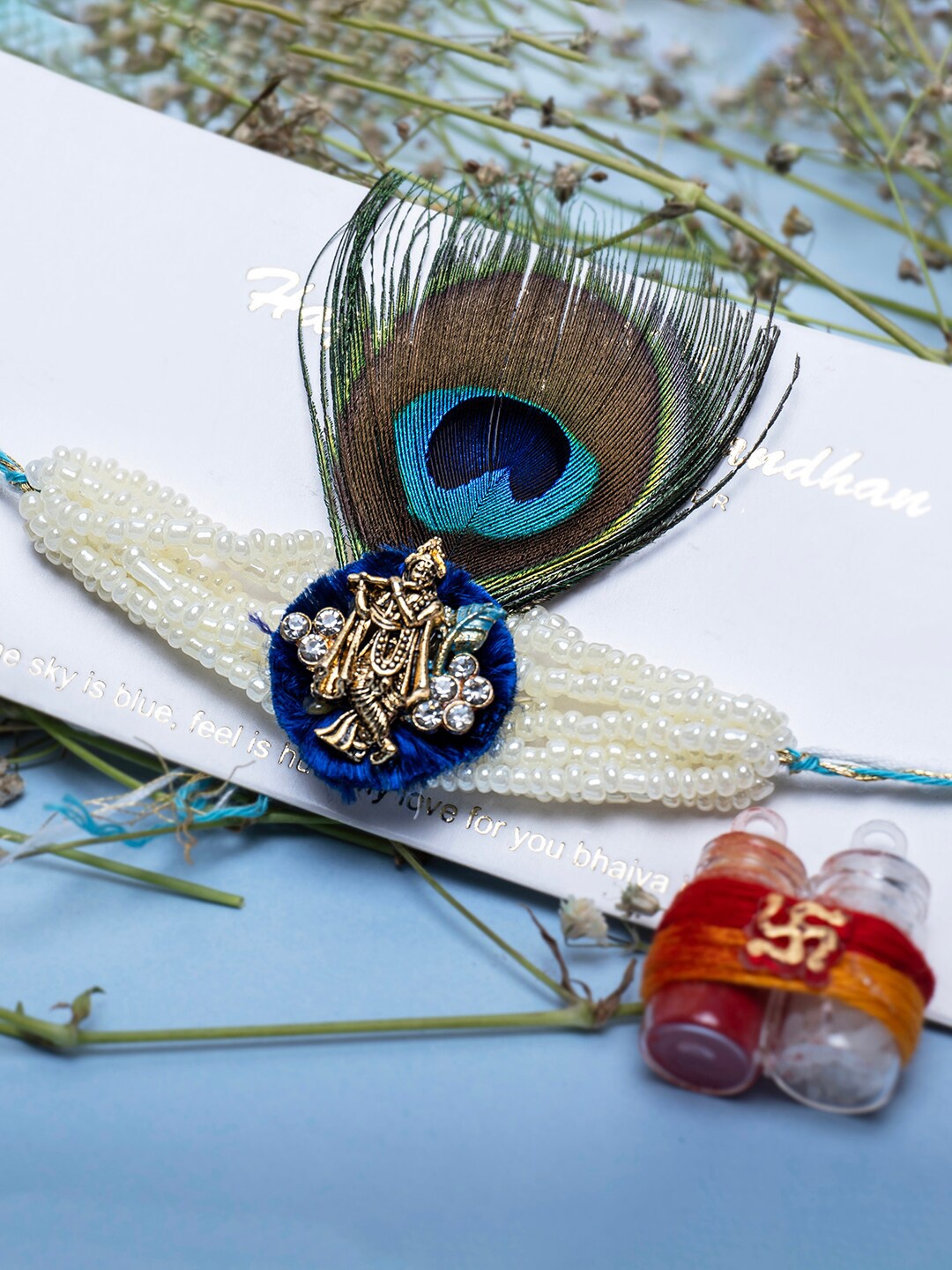 

PANASH Gold-Plated Krishna Peacock Feather Thread Rakhi With Roli Chawal, Blue