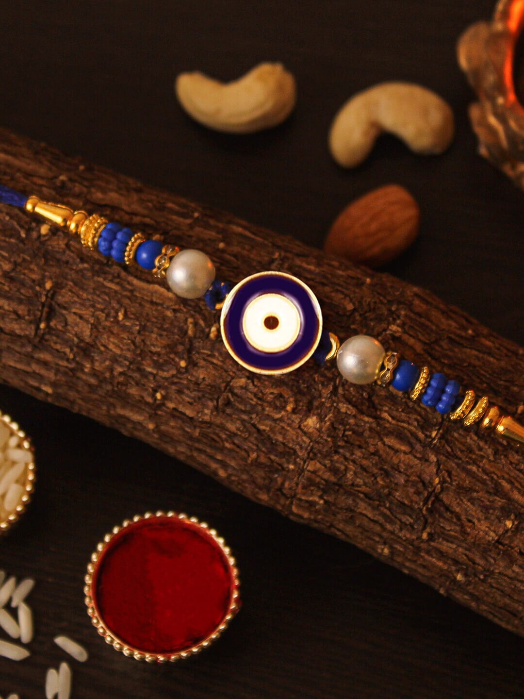 

TIED RIBBONS Unisex Evil Eye Rakhi with Cushion Card Roli Chawal Gift Set, Gold