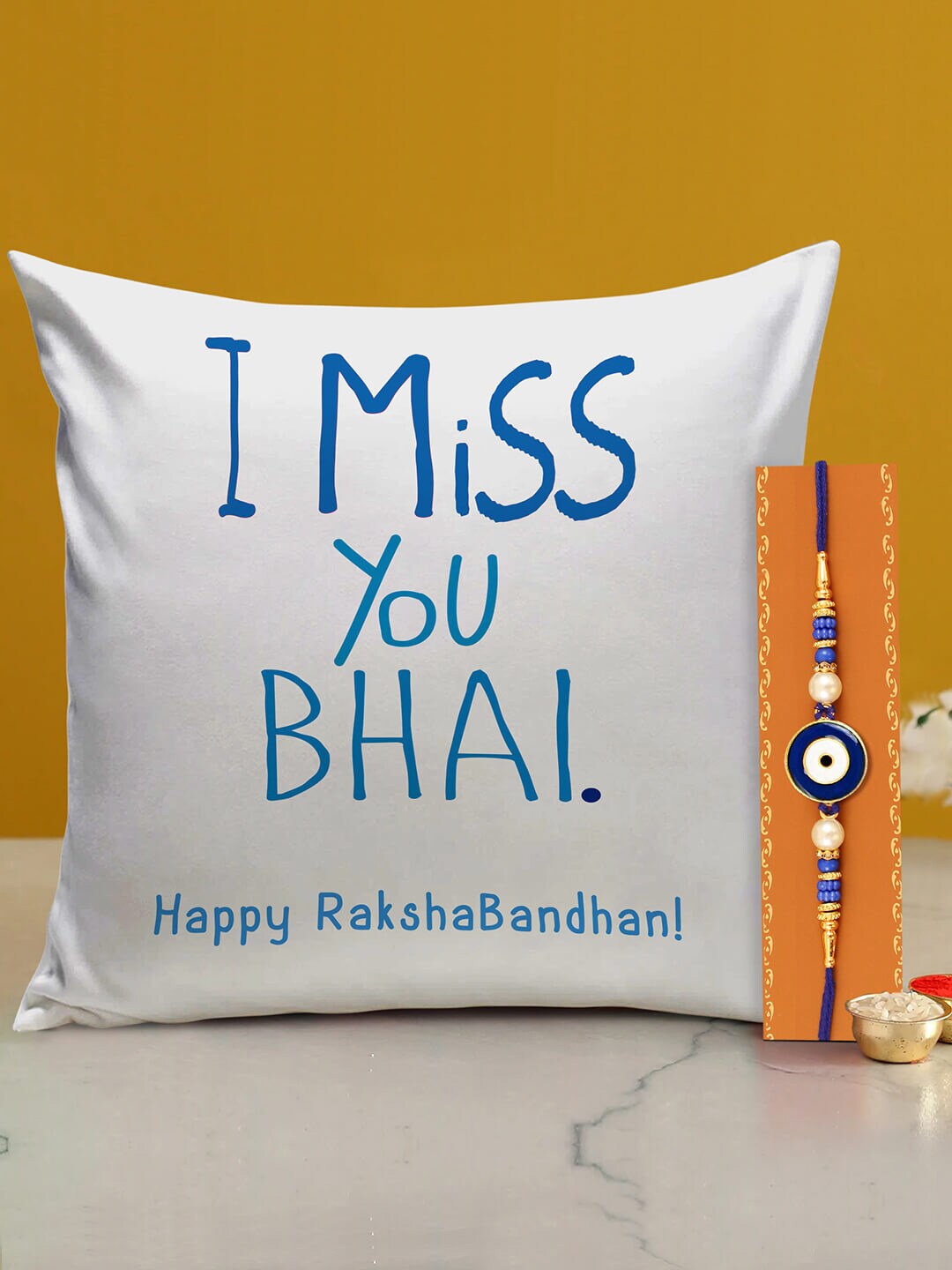 

TIED RIBBONS Unisex Evil Eye Rakhi Cushion Roli Chawal With Greeting Card Rakhi Gift Set, White