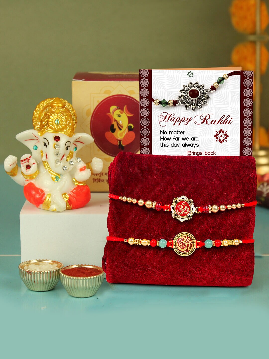 

TIED RIBBONS Set Of 2 Om Rakhi With Ganesha Statue Card & Roli Chawal, Red