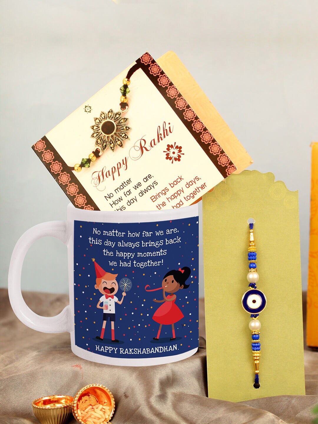 

TIED RIBBONS Evil Eye Charm Rakhi With Roli Chawal & Mug & Card Gift Set, Gold