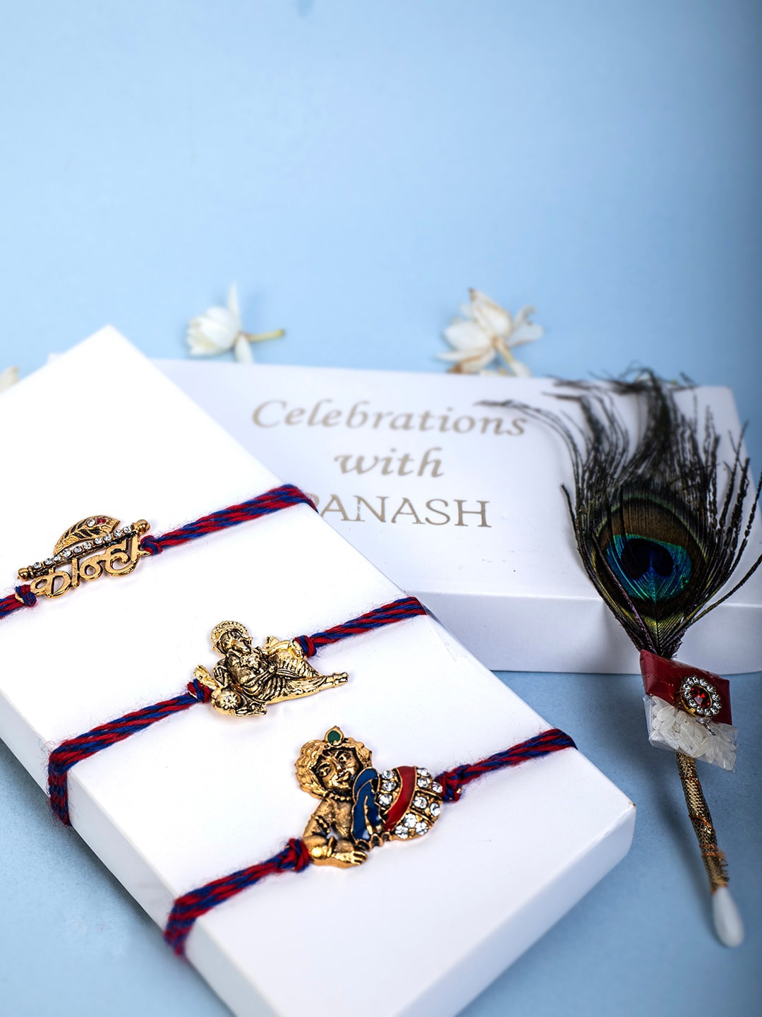 

PANASH Unisex Set of 3 Gold-Plated Thread Rakhi With Mor Pankh Stick & Roli Chawal