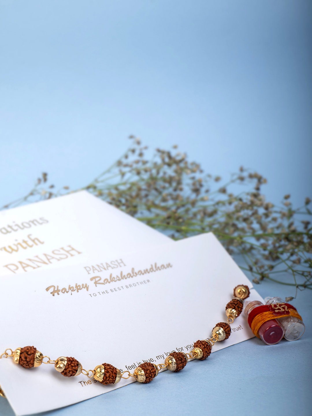 

PANASH Men Gold-Plated Rudraksh Rakhi With Roli Chawal
