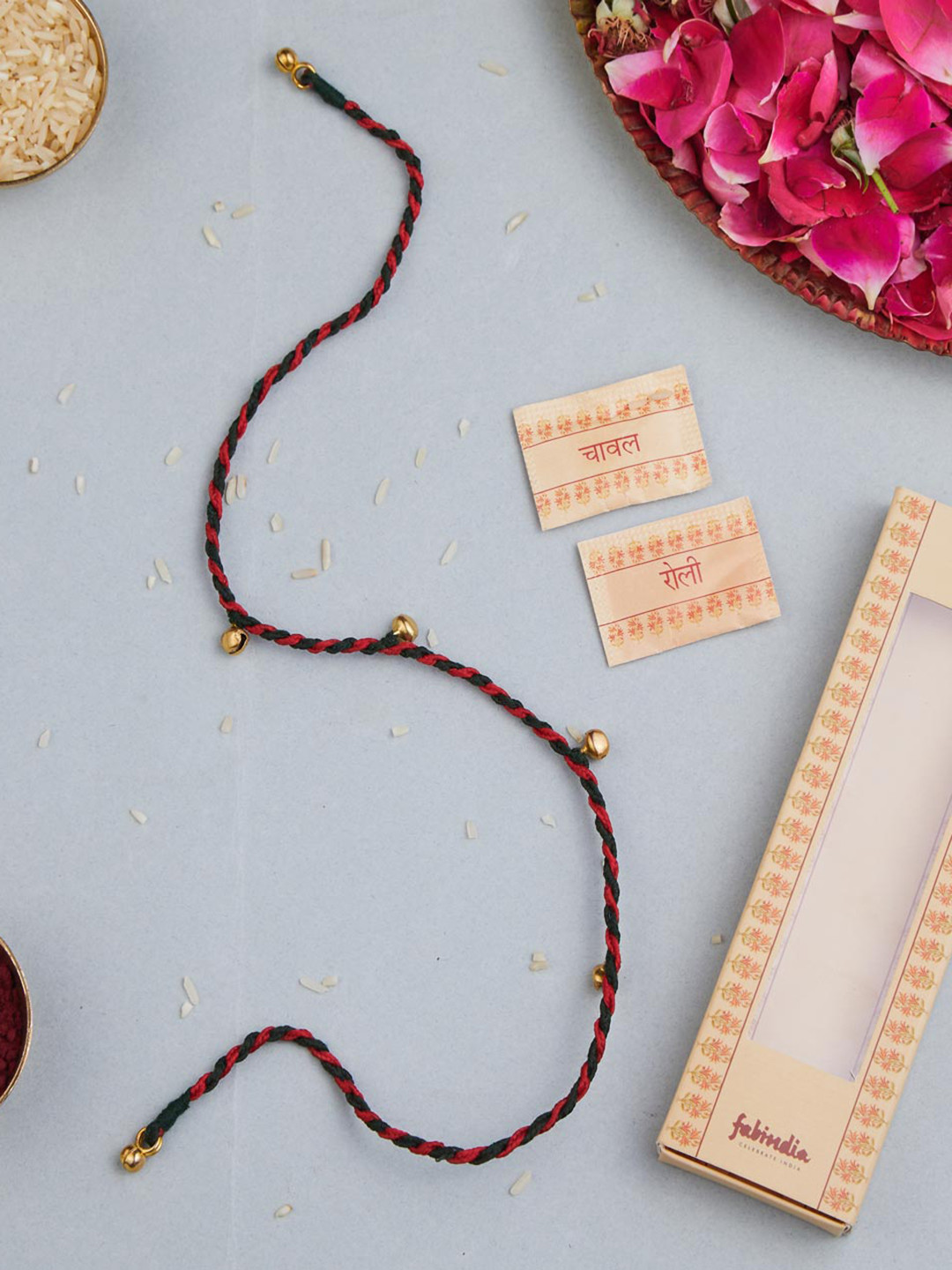 

Fabindia Gold-Plated Ghungroo Thread Rakhi With Roli & Chawal, Red