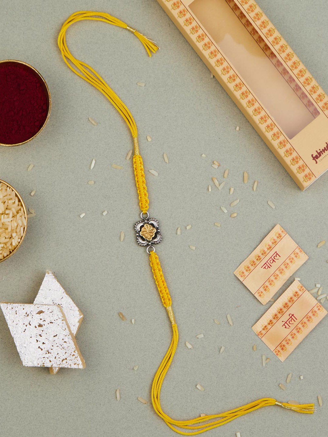 

Fabindia Two Tone Silver Rakhi With Roli & Chawal, Multi
