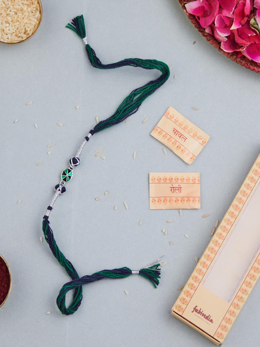 

Fabindia Unisex Silver Round Charm Thread Rakhi With Roli Chawl Pack