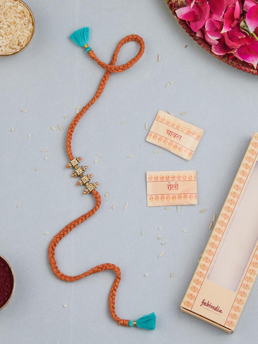 

Fabindia Unisex Metal Charm Rakhi With Roli Chawl Pack, Gold