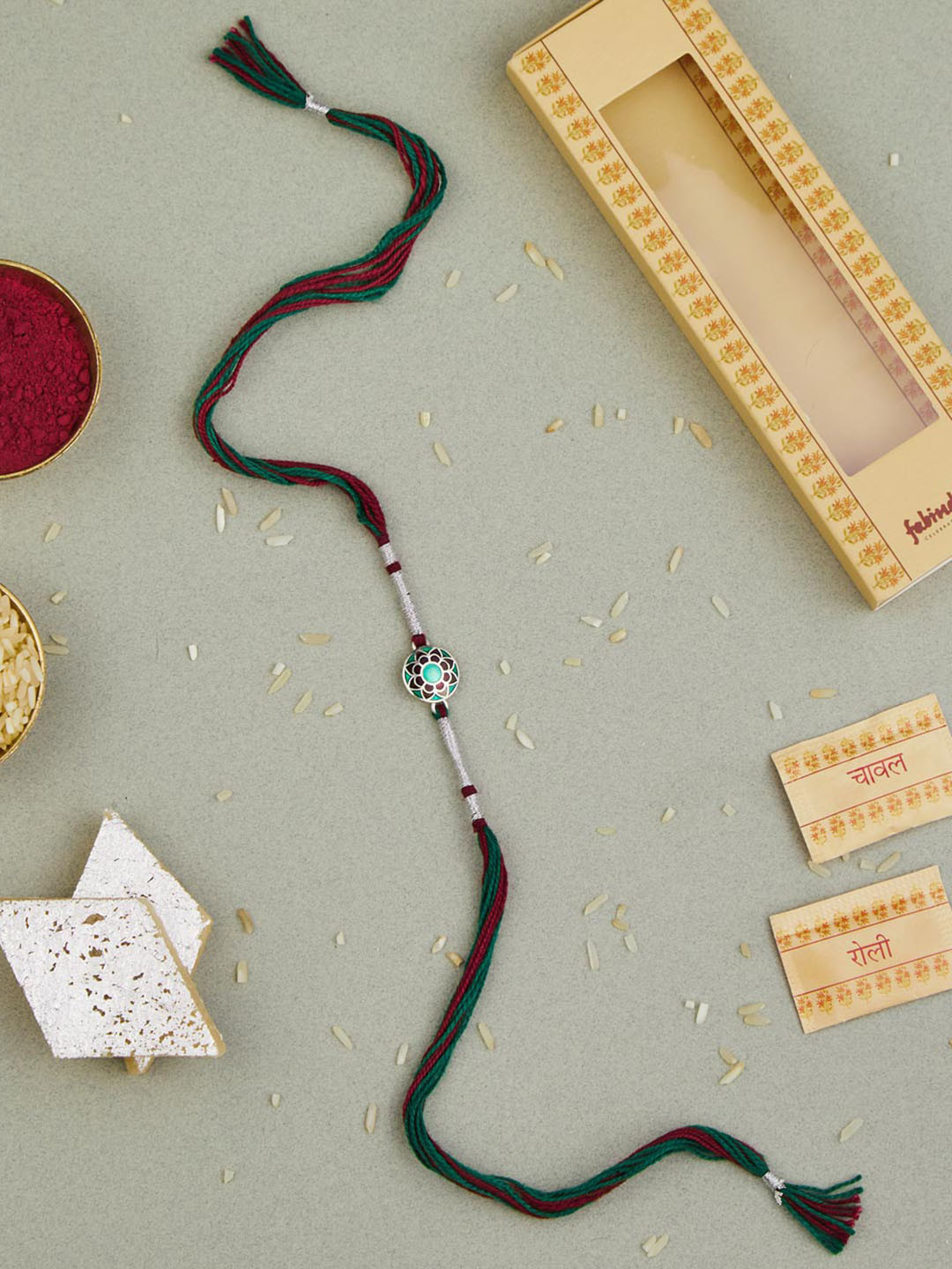 

Fabindia Silver Round Enamel Thread Rakhi With Roli Chawl