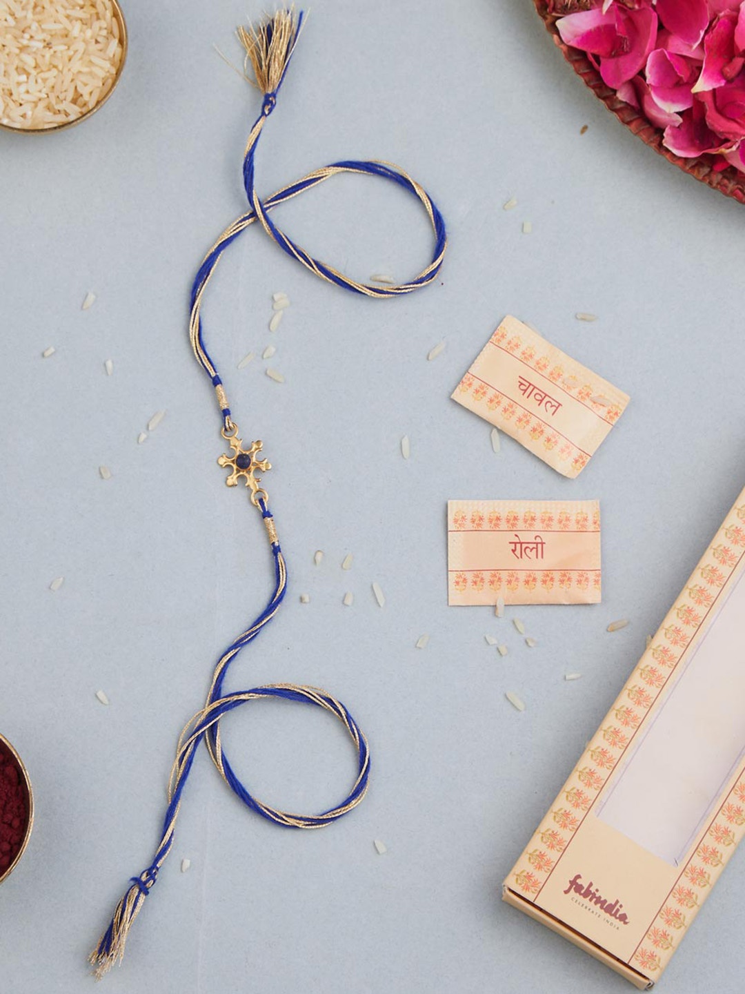 

Fabindia Unisex Gold Plated Silver Flower Rakhi With Roli Chawl Pack