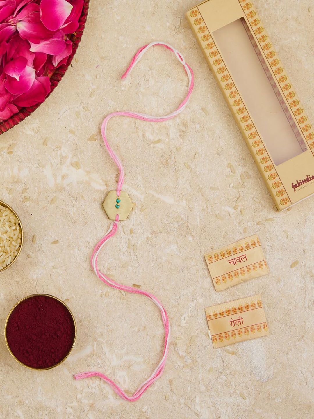 

Fabindia Unisex Gold Plated Metal Charm Thread Rakhi With Roli Chawl Pack