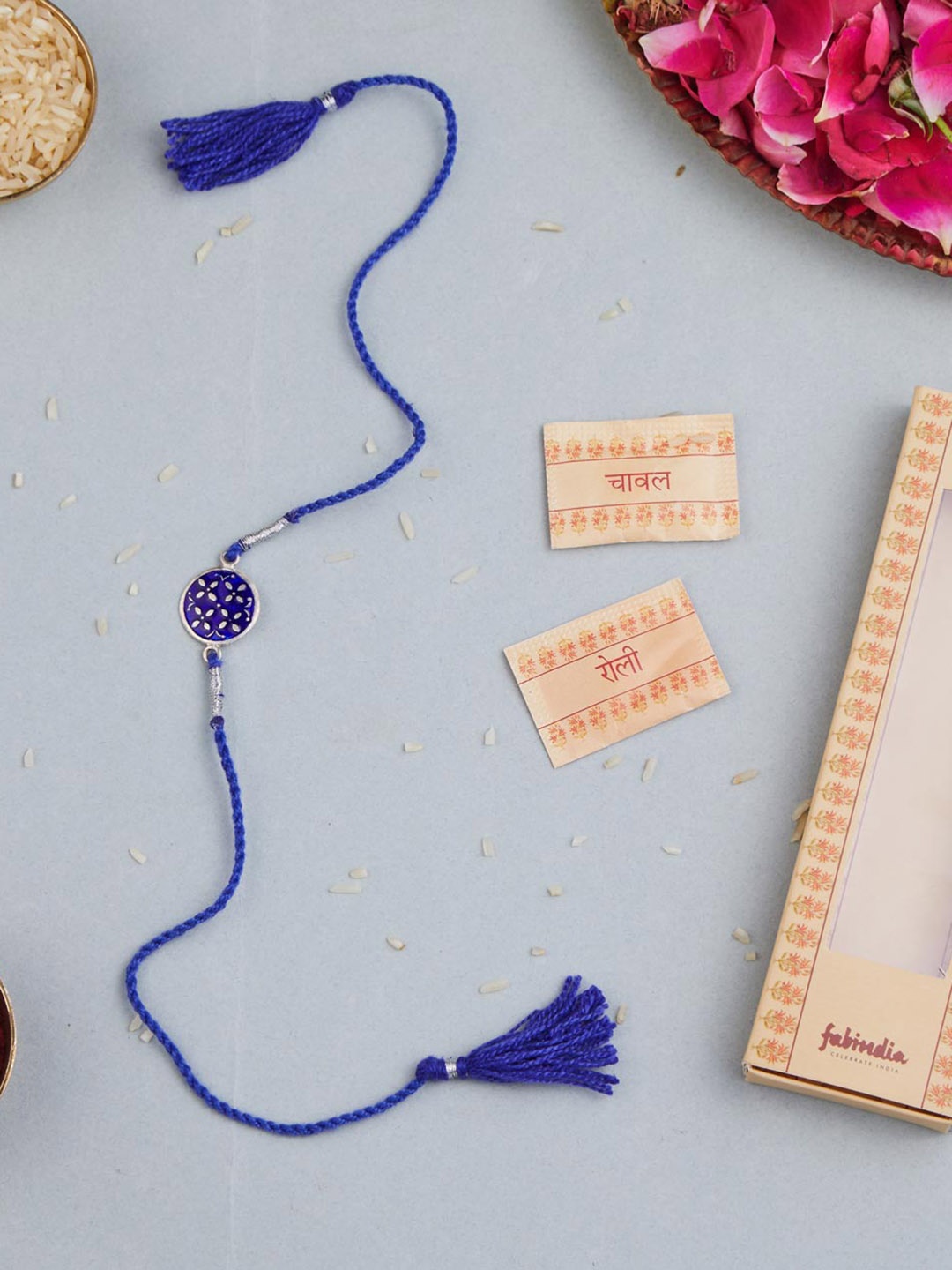 

Fabindia Unisex Silver Round Thread Rakhi With Roli Chawl Pack