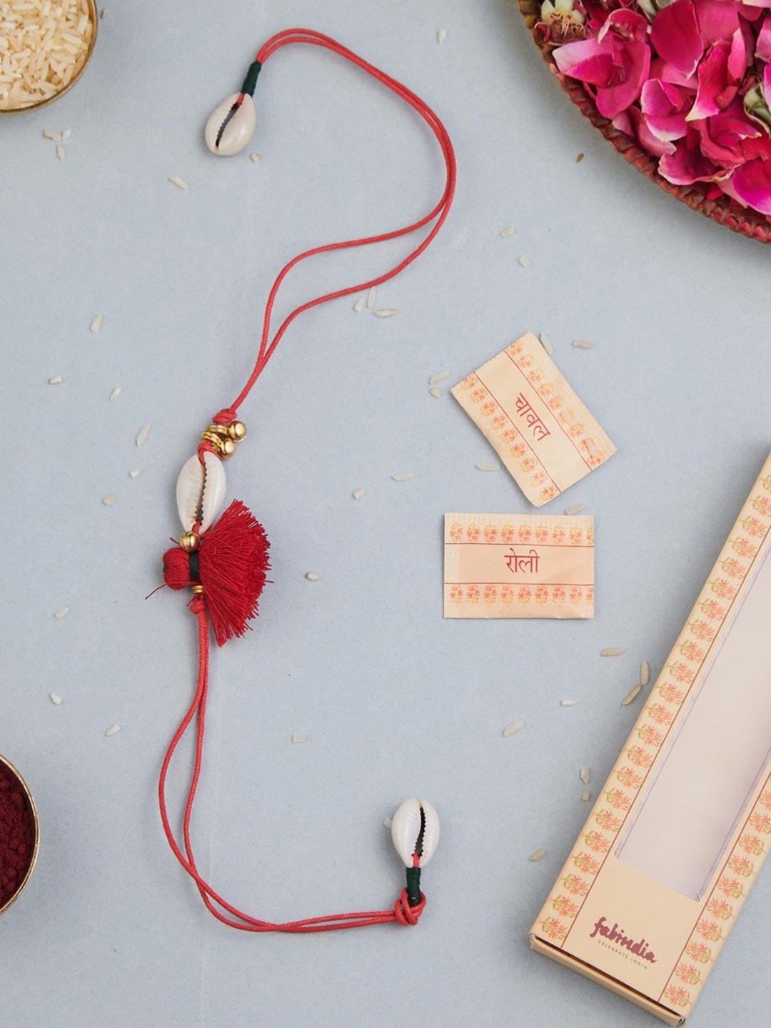 

Fabindia Unisex Shell Tassel Thread Rakhi With Roli & Chawal, Maroon