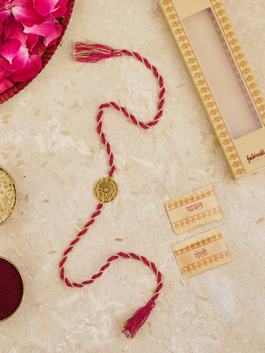 

Fabindia Unisex Gold-Plated Thread Rakhi With Roli Chawl Pack