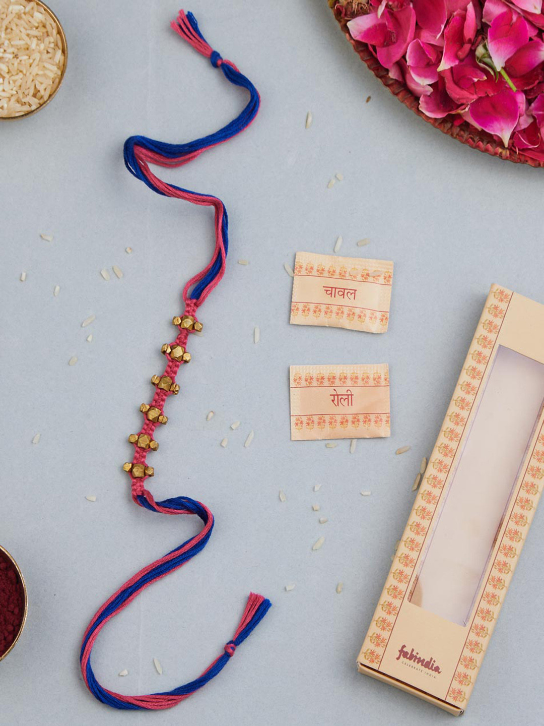 

Fabindia Unisex Dokra Thread Rakhi With Roli Chawl Pack, Gold