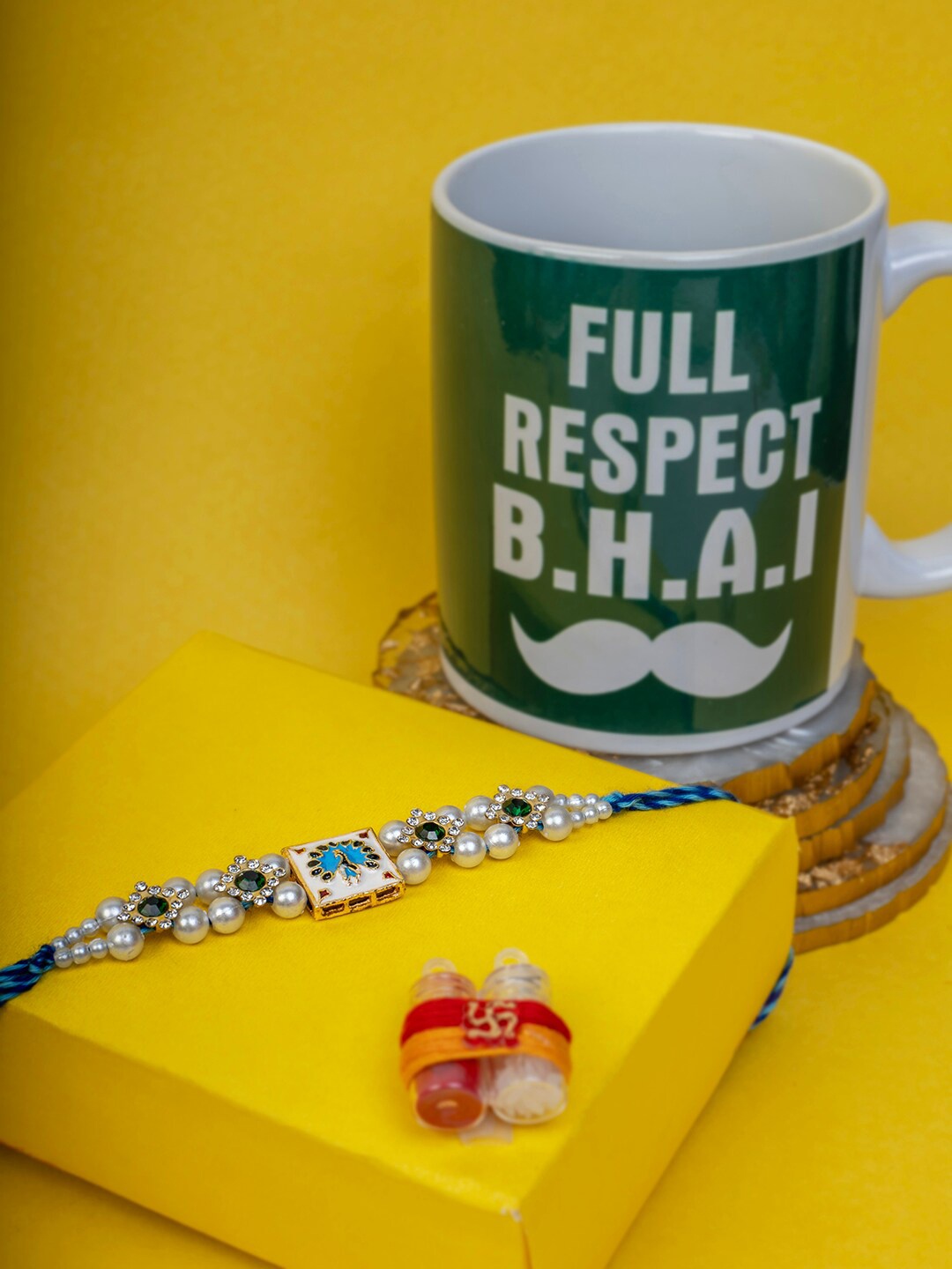 

PANASH Gold Plated Rakhi with Mug Roli & Rice