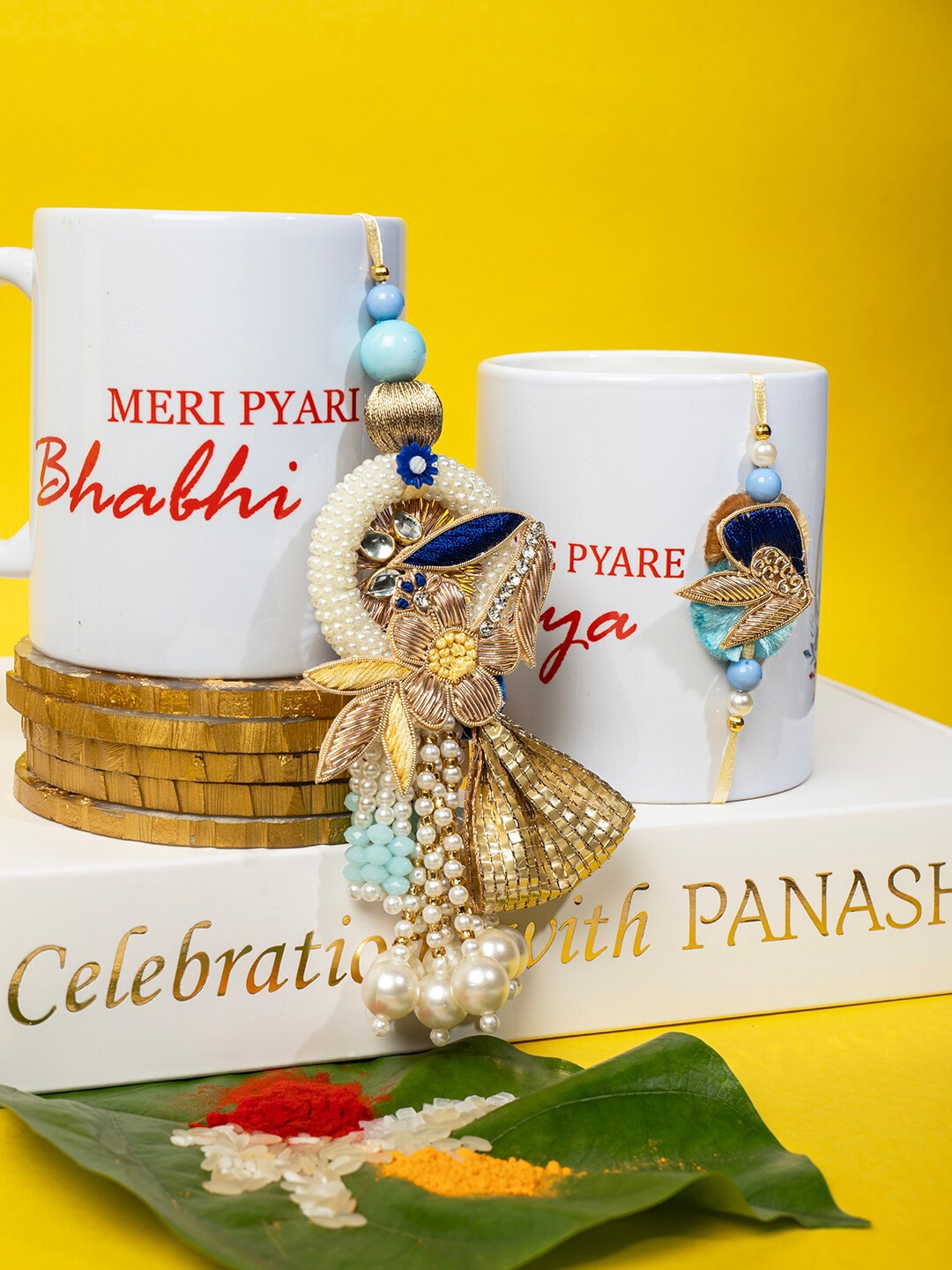 

PANASH Set Of 2 Stone-Studded & Pearl-Beaded Rakhis With Mug & Roli Chawal, Blue