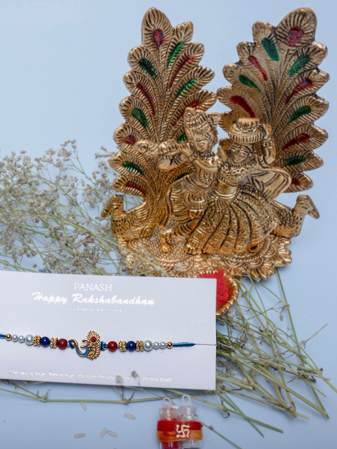

PANASH Gold-Plated Beaded Rakhi Radha Krishna & Roli Chawal Gift Set