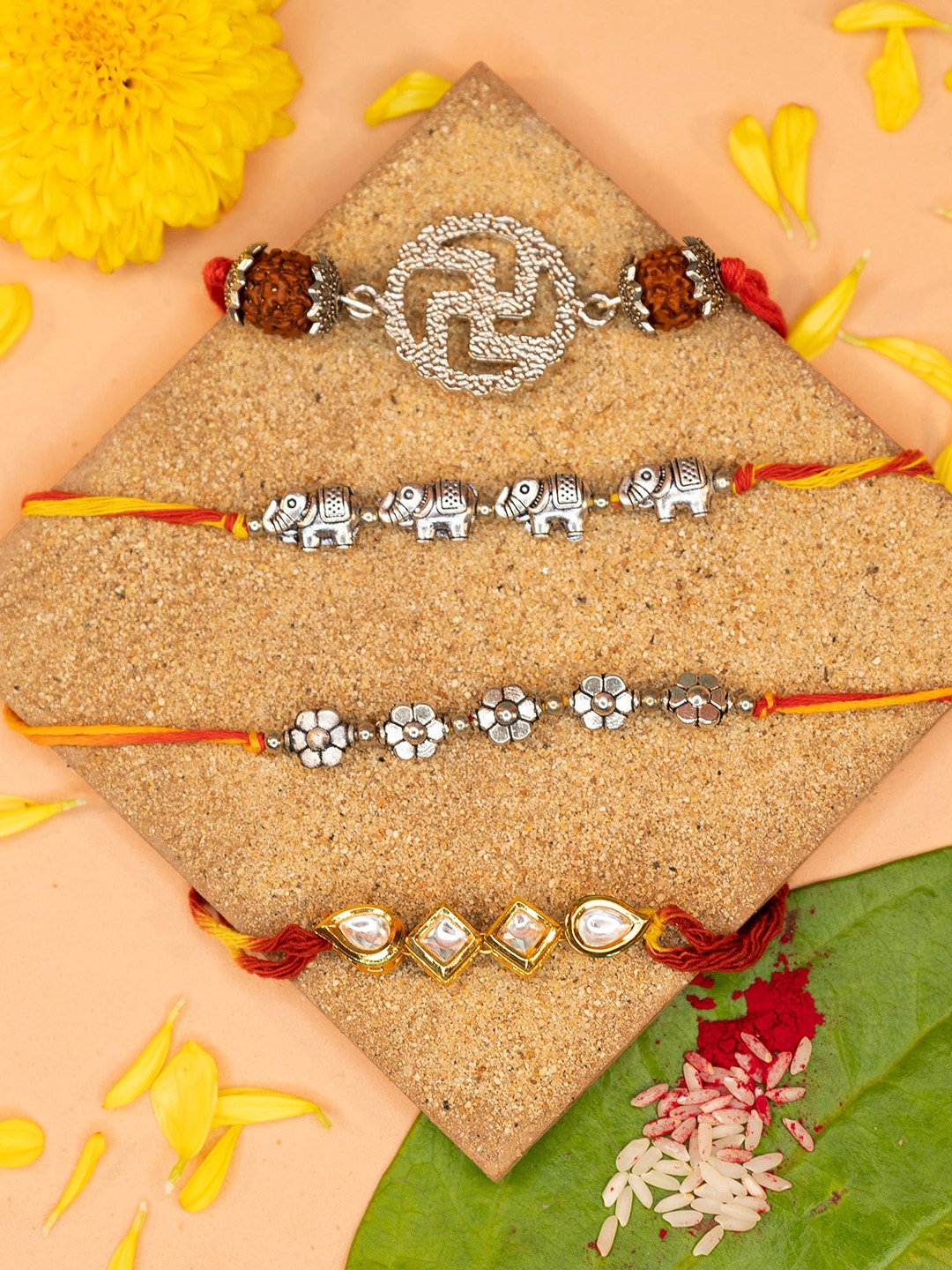 

Yellow Chimes Set Of 4 Thread Rakhis With Roli Chawal & Greeting Card, Silver