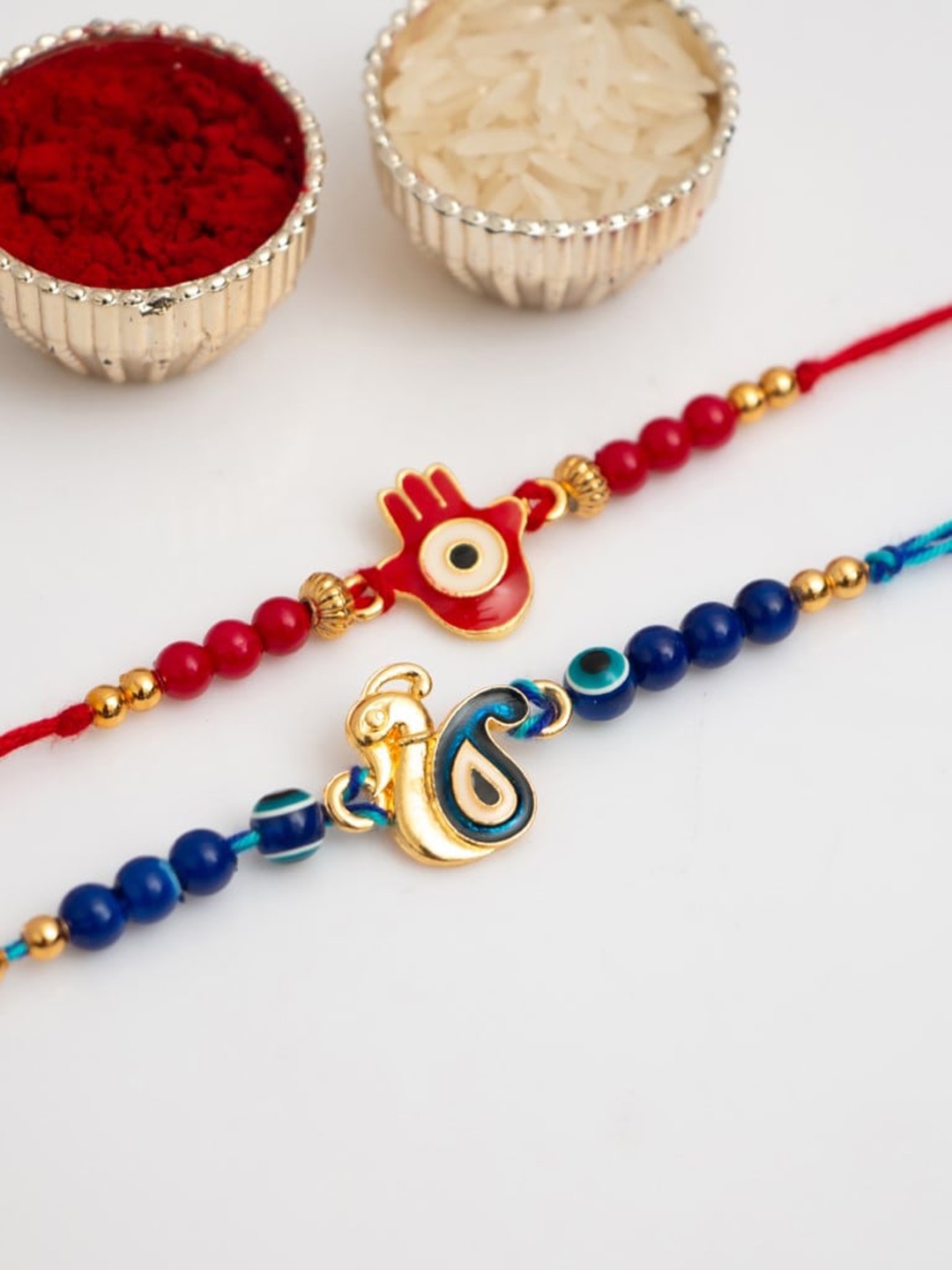 

CraftVatika Unisex Set of 2 Evil Eye & Peacock Thread Rakhi, Red