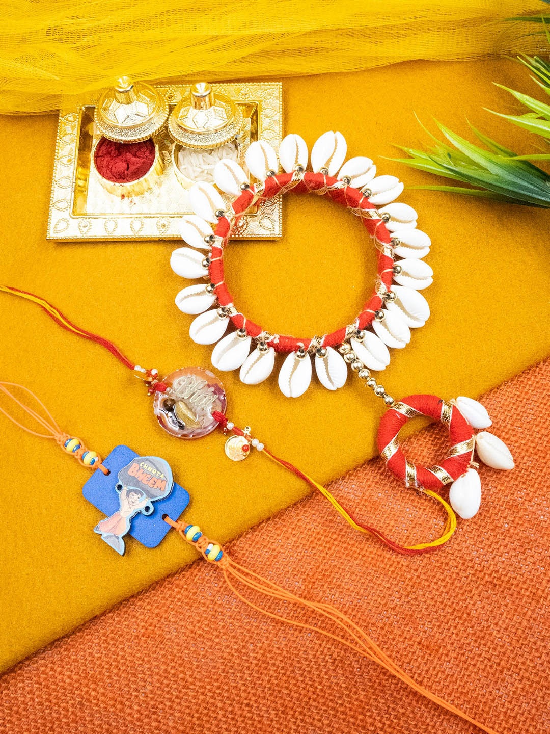 

StileAdda Unisex Set Of 3 Family Beaded & Motu Patlu Rakhi With Roli Chawal Holder, White