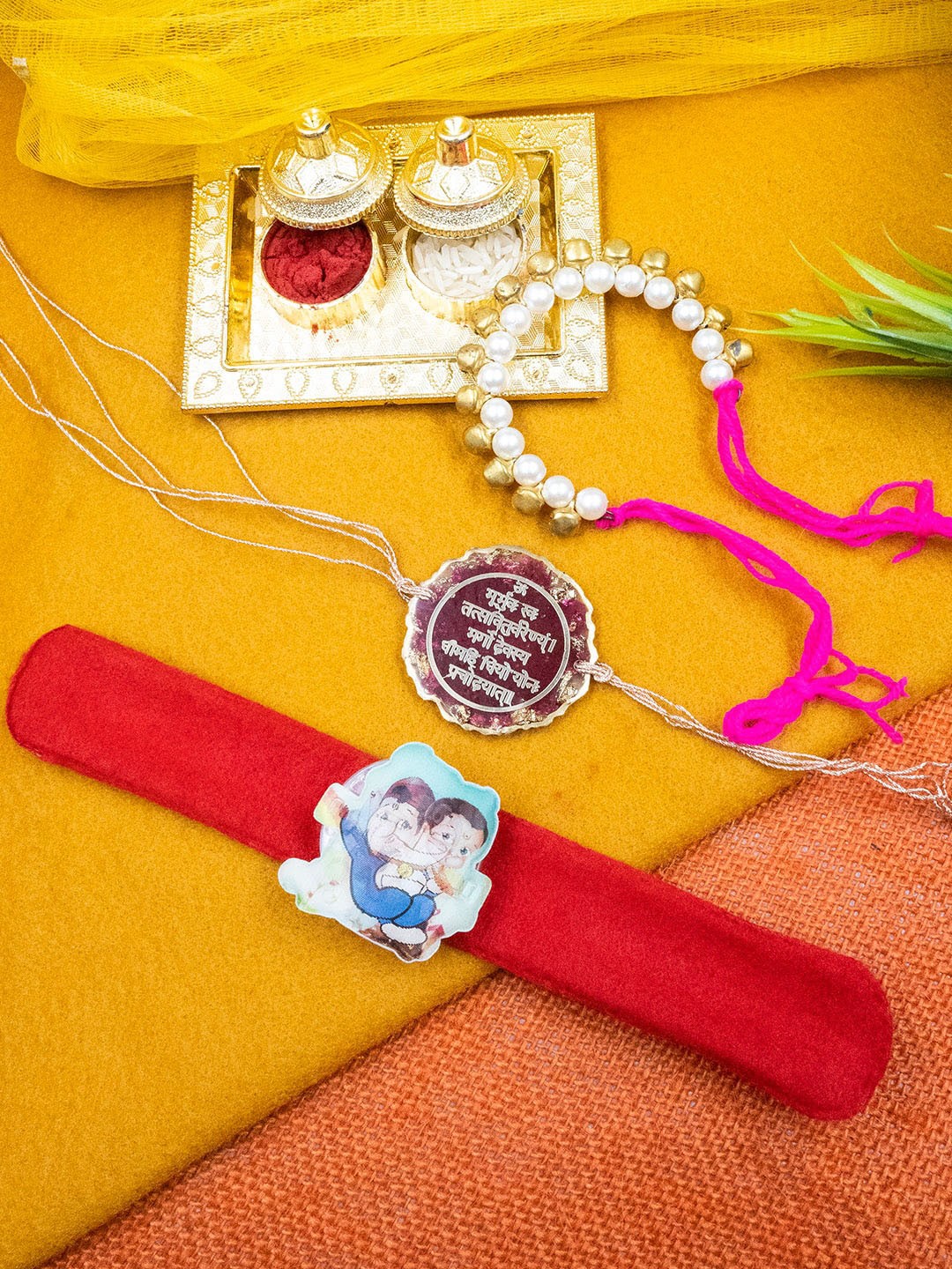 

StileAdda Unisex Set Of 3 Family Beaded & Doremon Rakhi With Roli Chawal Holder, Pink