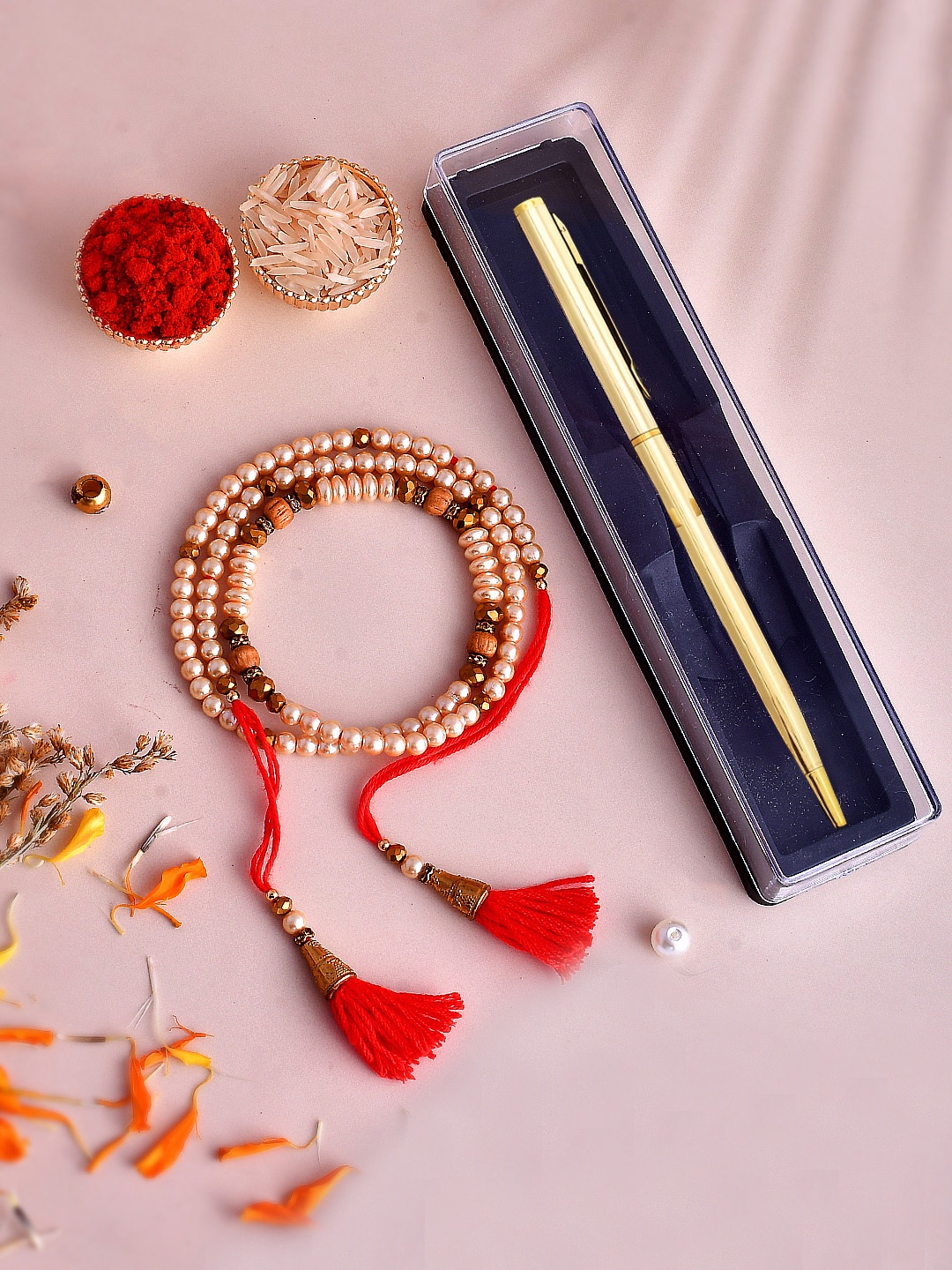 

Shoshaa Pearl Beaded Bhaiya Rakhi with Pen Gift Set Roli Chawal, Red