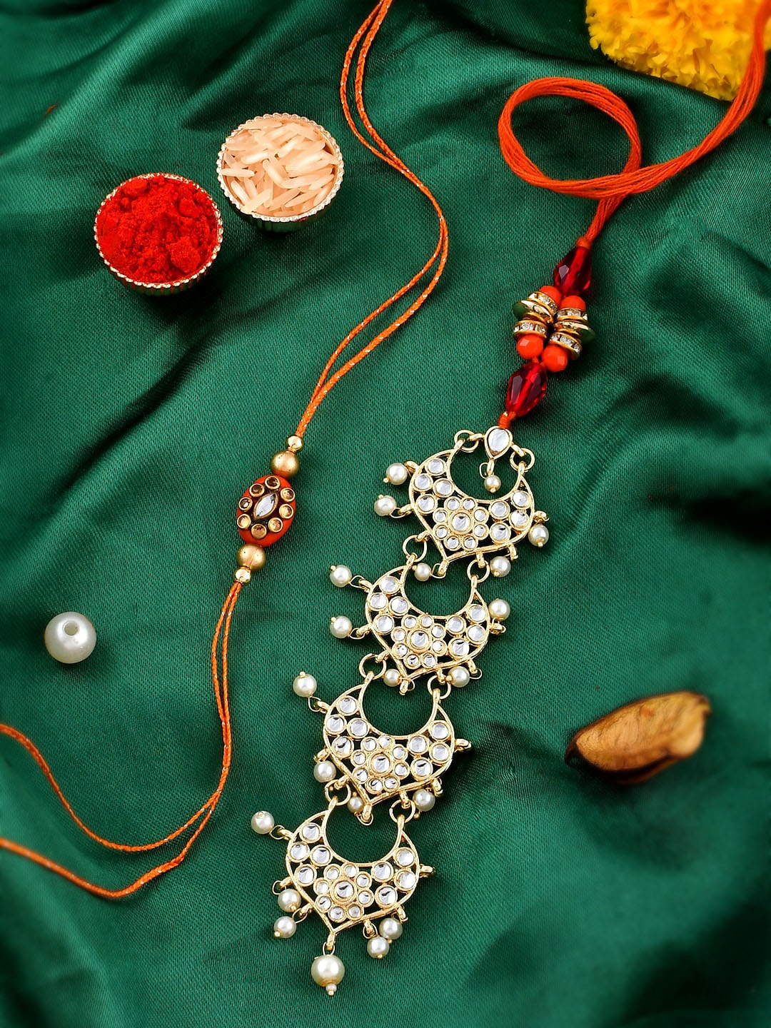 

Shoshaa Set Of 2 Gold-Plated Orange Kundan lumba Bhaiya Bhabhi Rakhi Set Maangtika Gift Set with Roli Chawal