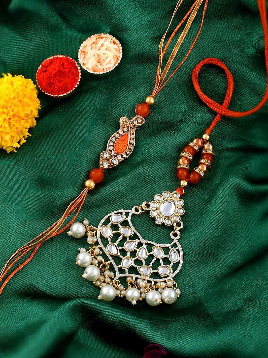 

Shoshaa Kundan Bhaiya Bhabhi Rakhi Lumba Maangtika With Roli Chawal Earrings Gift Set, Orange