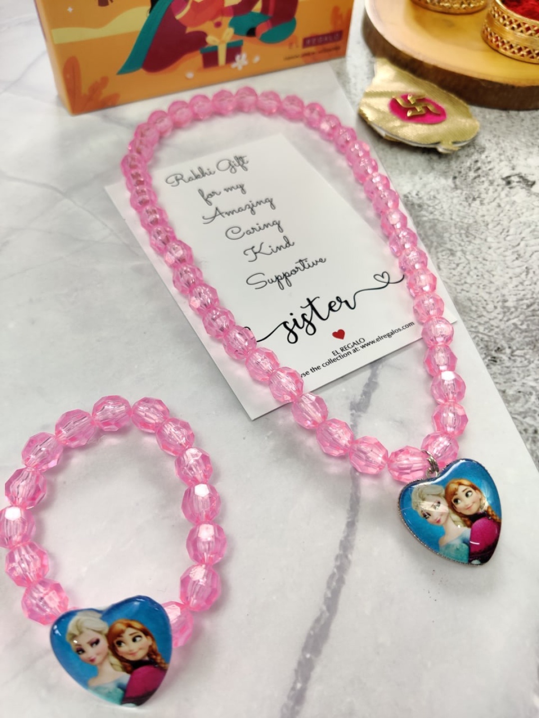 EL REGALO Girls Set of 2 Elsa Rakhi Gift Set, Pink