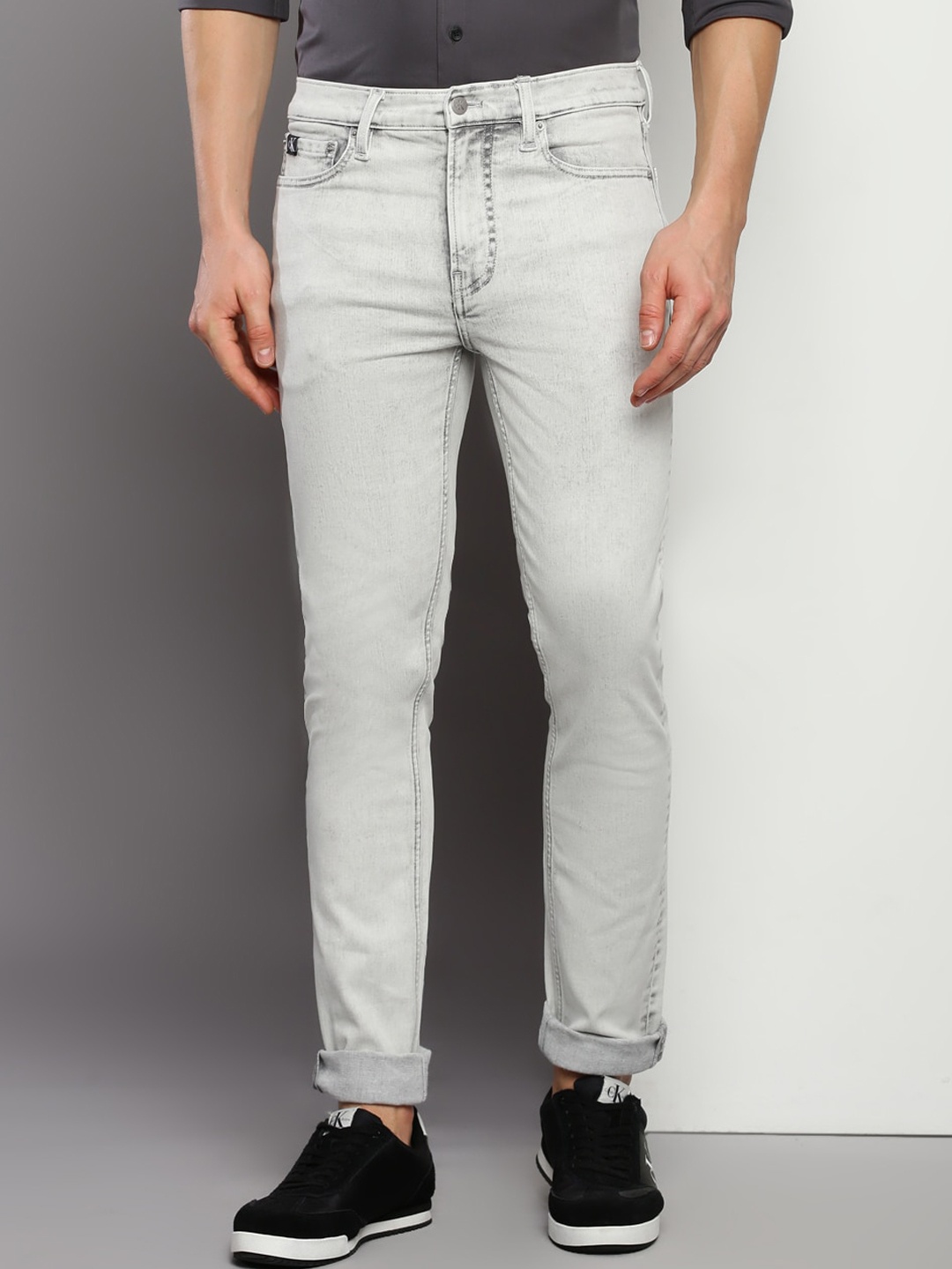 

Calvin Klein Jeans Men Skinny Fit Mid Rise Light Shade Clean Look Cotton Jeans, Grey