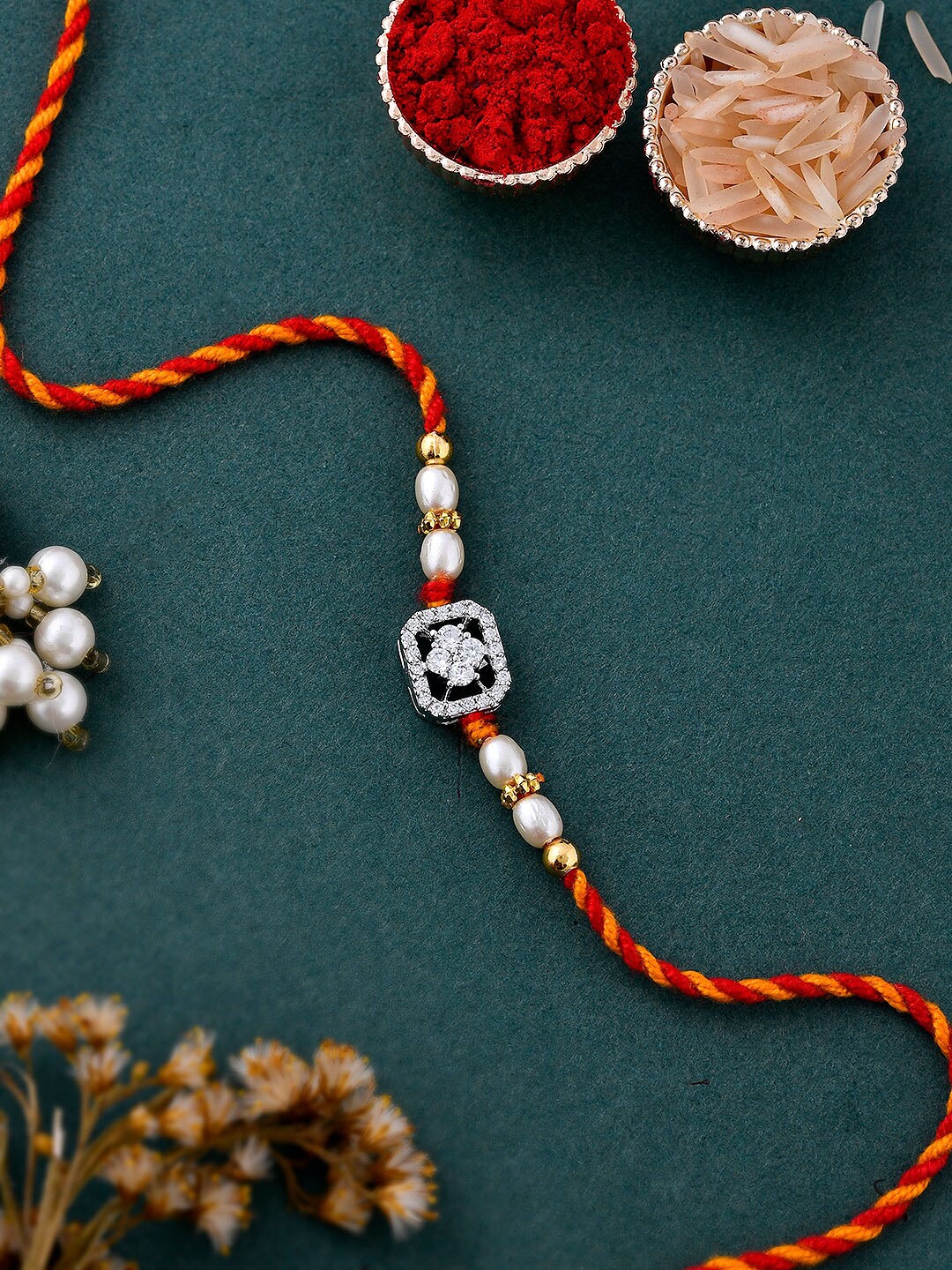 

Aapno Rajasthan Unisex Set Of 4 AD Studded Exquisite Braided Silver Rakhi Gift Set, Red