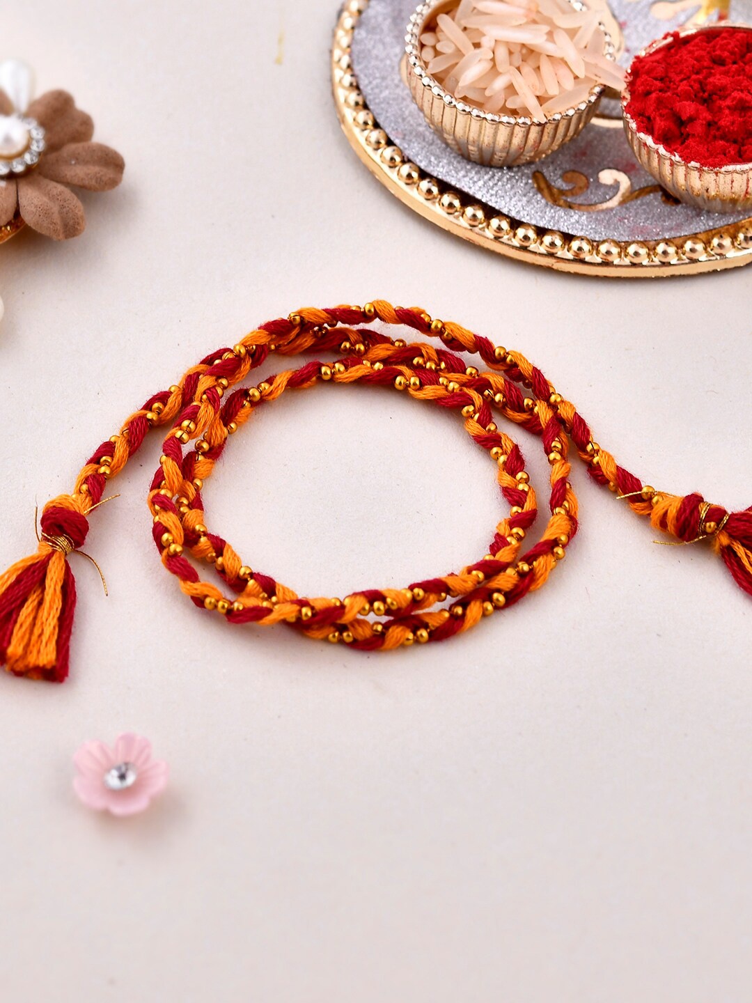 

Aapno Rajasthan Mne Ghungroo Braided Moli Bhaiya Rakhi With Roli Chwal & Card, Red