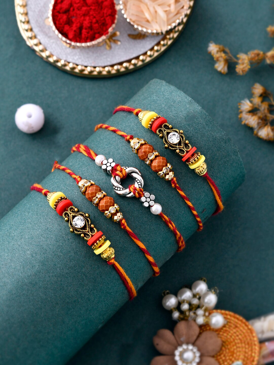 

Aapno Rajasthan Unisex Set Of 5 Traditional Stud Rakhi With Roli Chwal & Card, Red