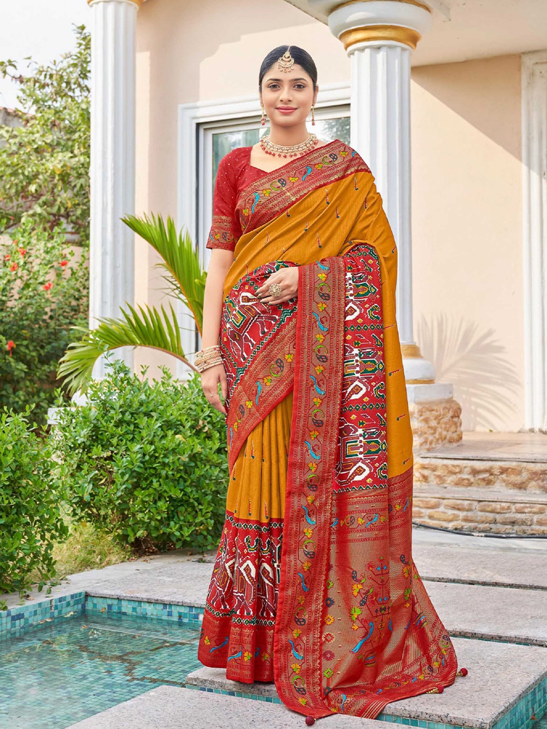 

Mitera Yellow & Red Ethnic Motifs Printed Zari Patola Saree