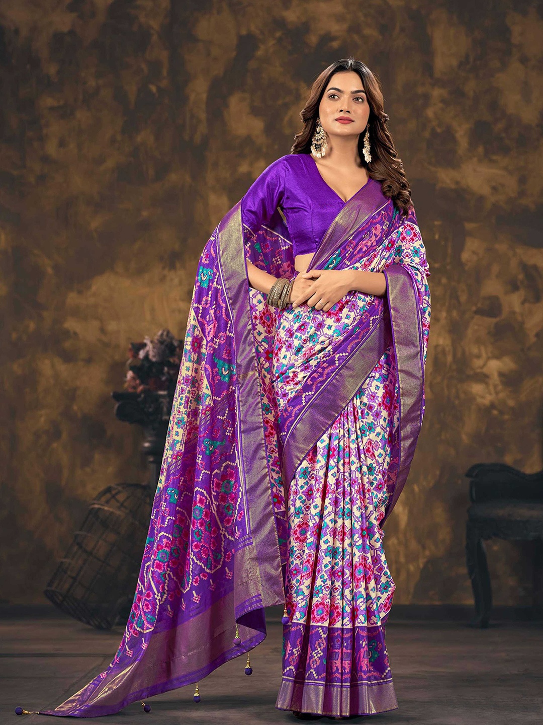 

Mitera Purple & White Ethnic Motifs Printed Zari Silk Blend Patola Saree