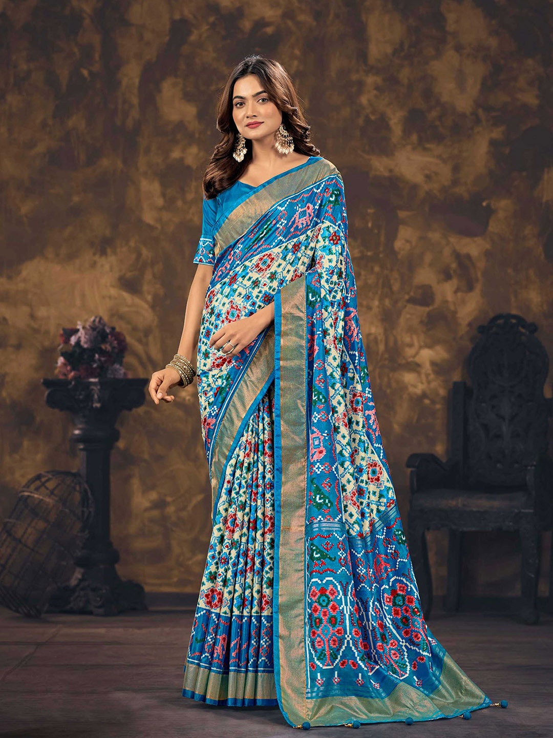 

Mitera Blue & Red Ethnic Motifs Printed Zari Silk Blend Patola Saree