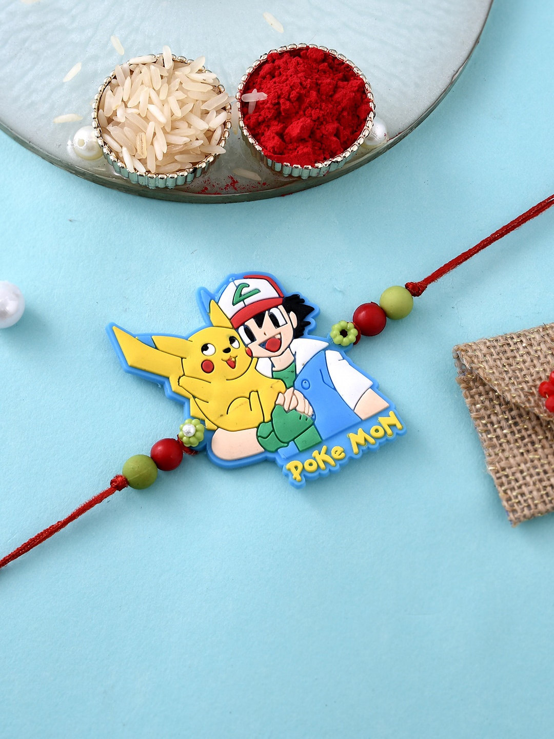 

Aapno Rajasthan Kids Pokemon Sticker Charm Rakhi With Roli Chawal & Greeting Card, Red