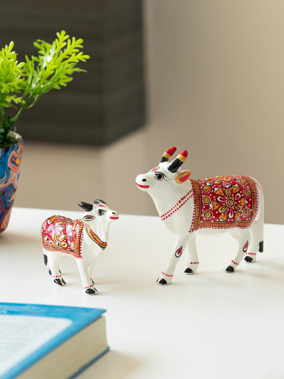 

ExclusiveLane White & Red 2 Pieces Cow & Calf Meenakari Showpieces