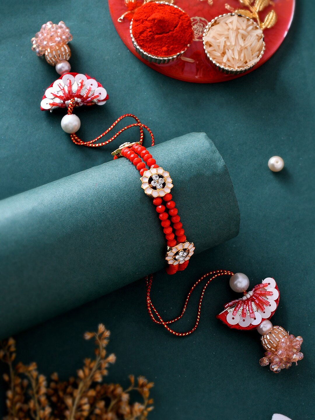 

Aapno Rajasthan Embellished Lumba Rakhi with Greeting Card & Roli Chawal, Red