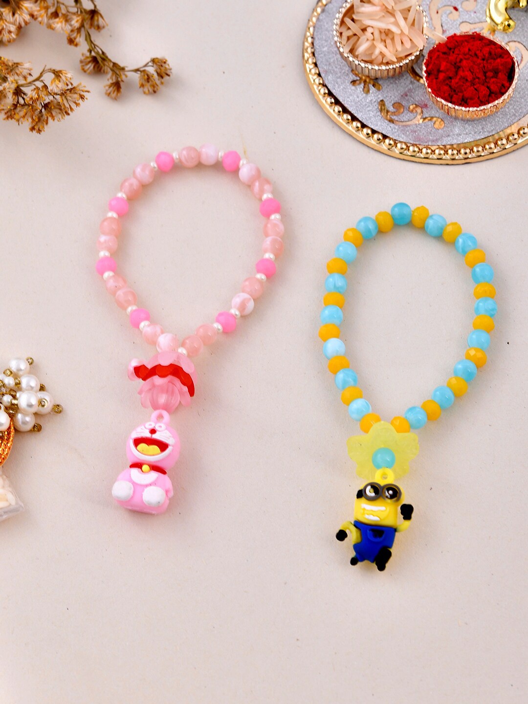 

Aapno Rajasthan Kids Set of 2 Beaded Rakhis With Roli Chawal & Card, Pink